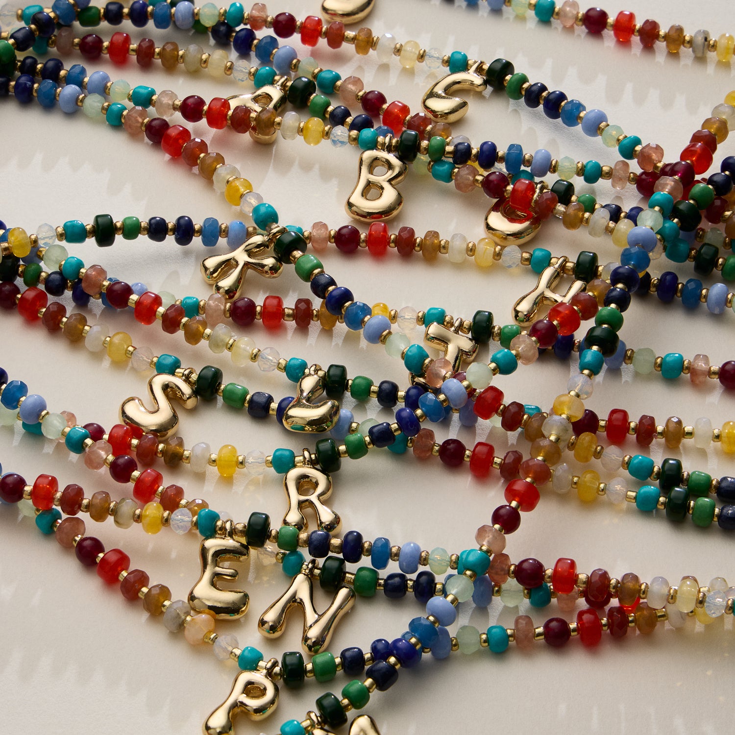 Vibrant Beaded Necklaces with Gold Initial Charms – Set of 16 Unique Designs