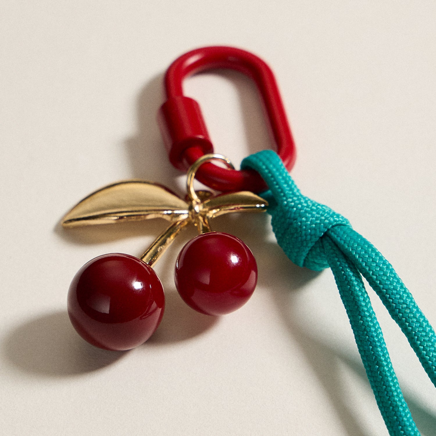 Gold-Tone Cherry Enamel Keychain with Braided Rope Detail