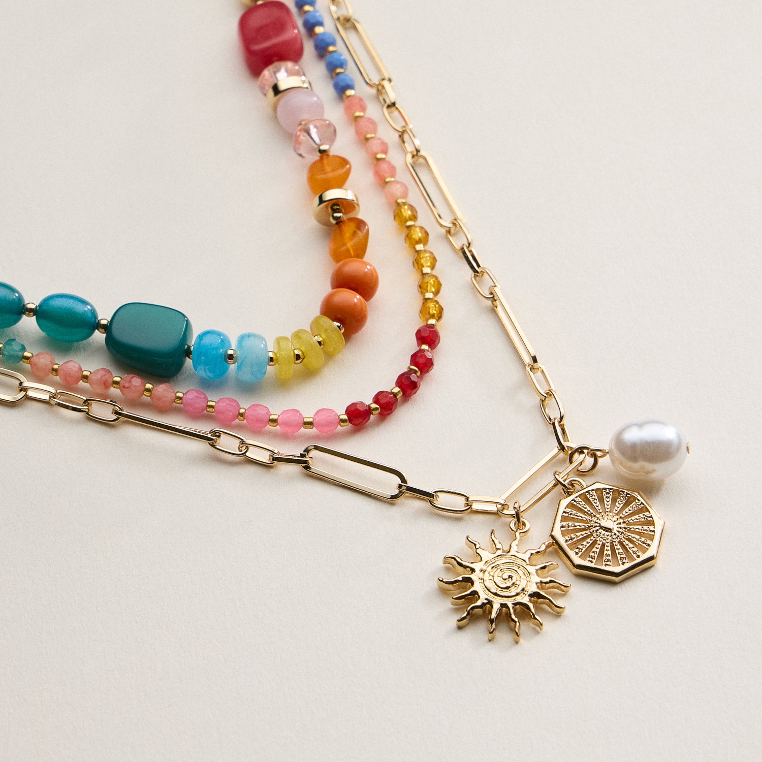 Layered Beaded and Chain Necklace with Sun and Pearl Charms – Gold Accent Design