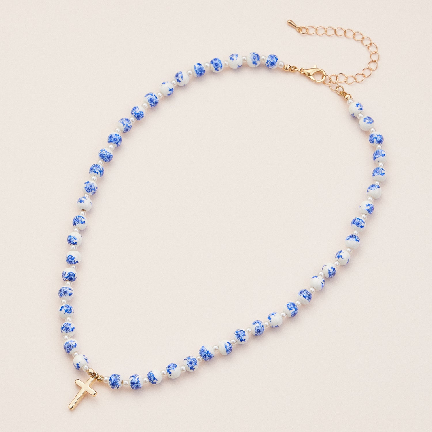 Elegant Blue and White Ceramic Beaded Necklace with Gold Cross Pendant