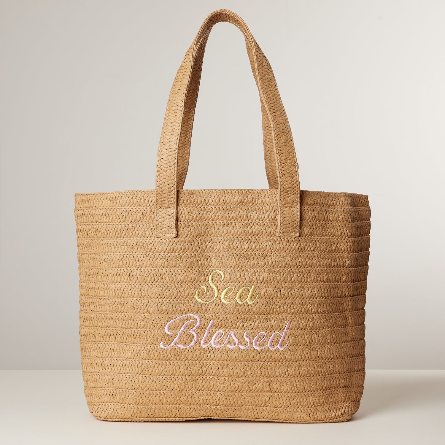 Sun Blessed Raffia Tote – Embroidered Woven Bag with Tassel Accent