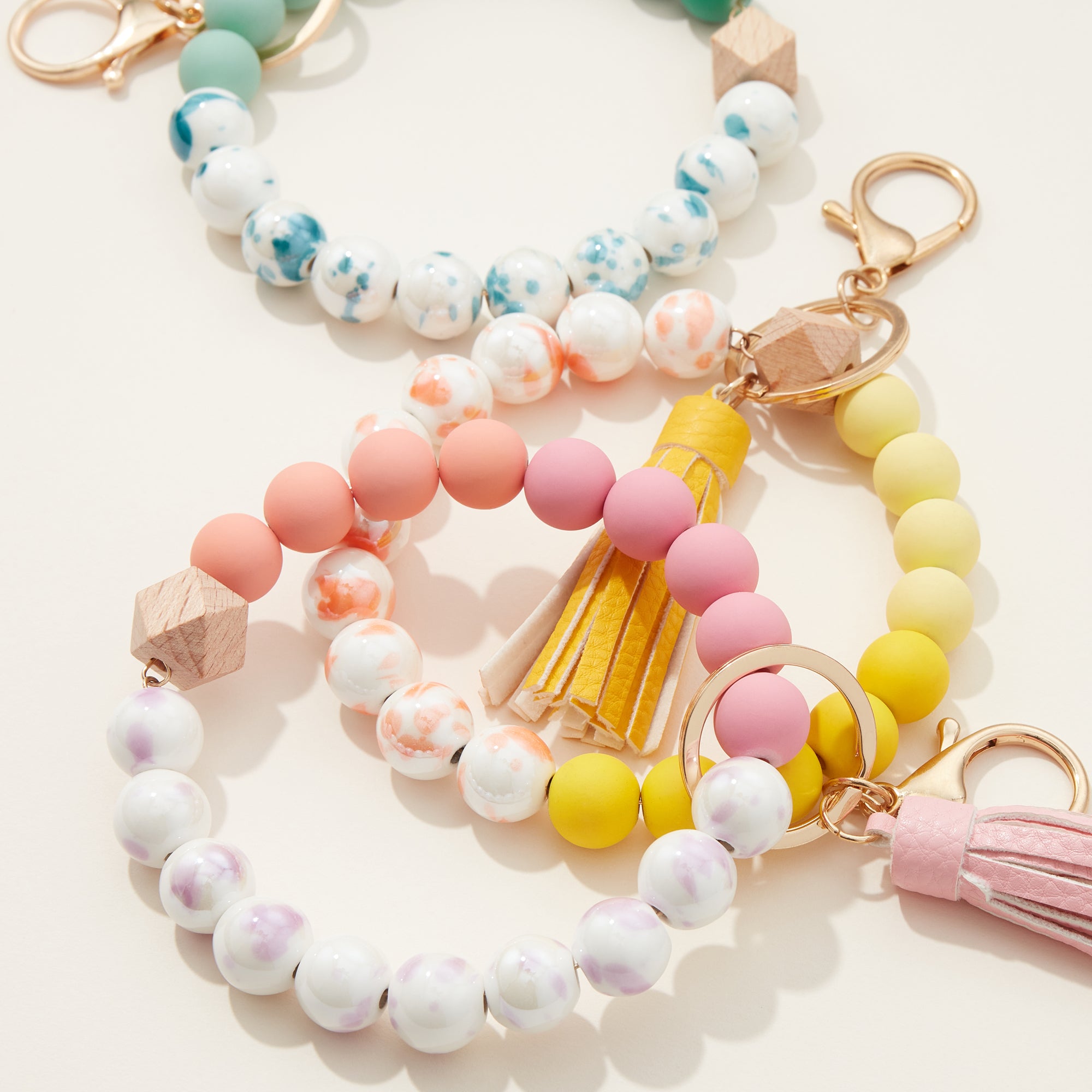 Ceramic and Silicone Coated Bead Bracelet Keychains with Tassel