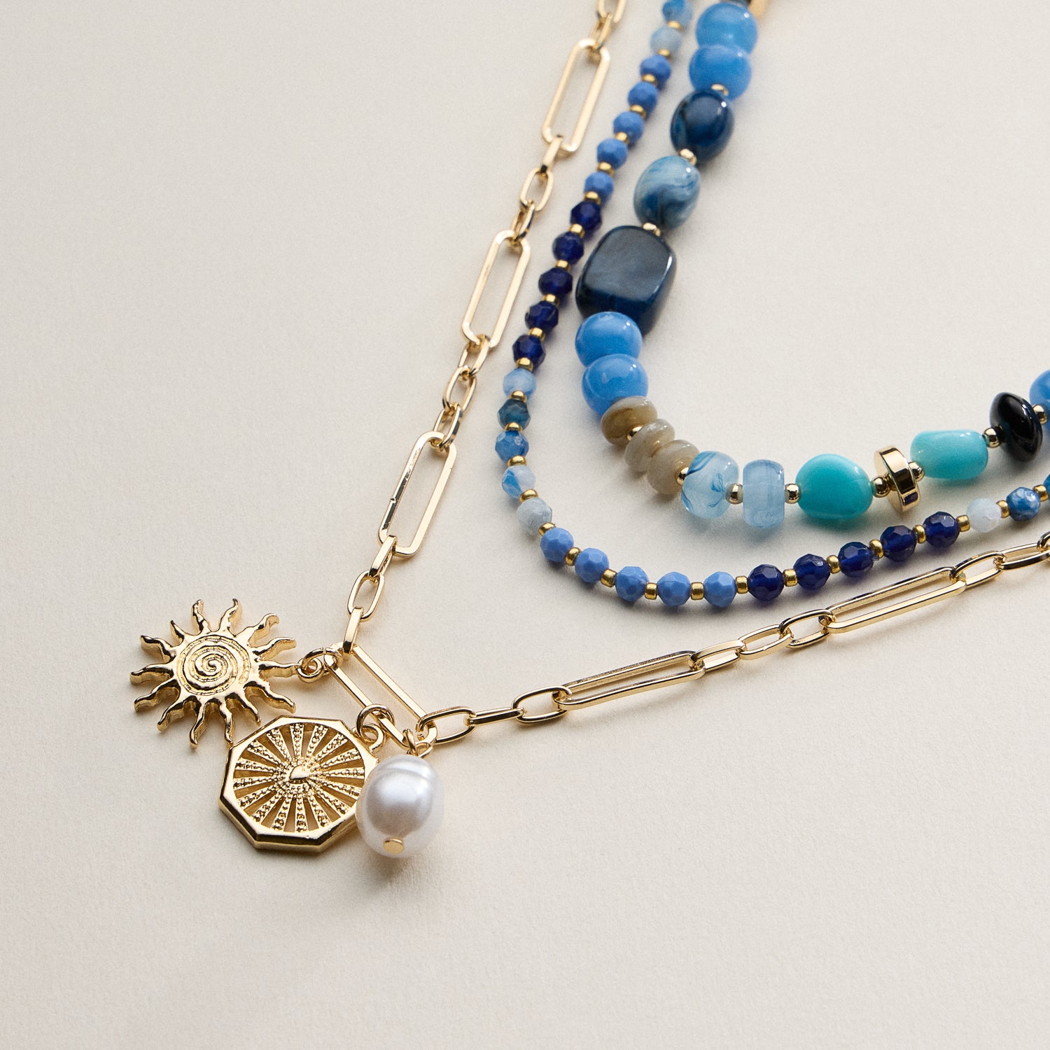 Layered Beaded and Chain Necklace with Sun and Pearl Charms – Gold Accent Design