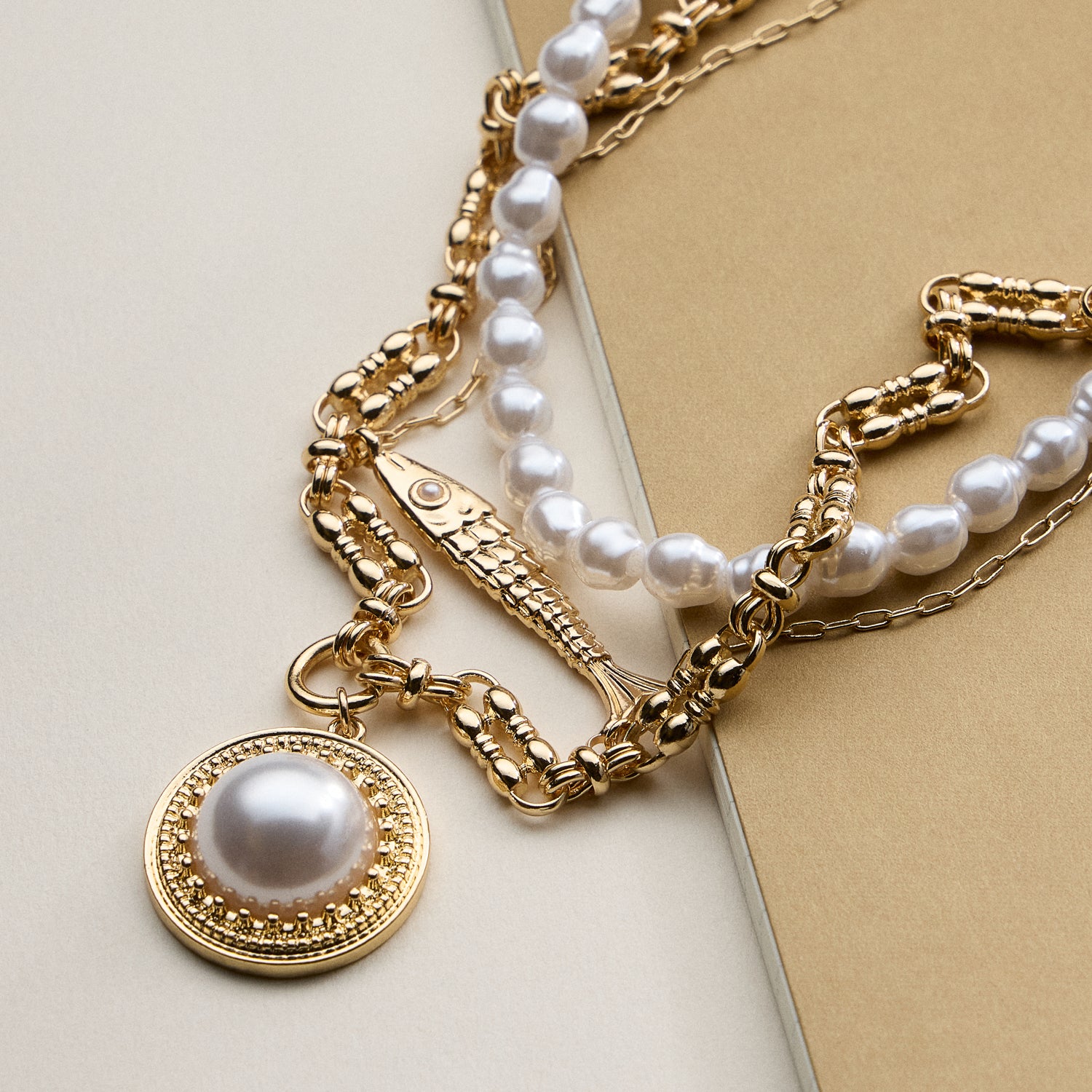 Layered Pearl and Chain Necklace with Round Pendant – Fish Link Detail