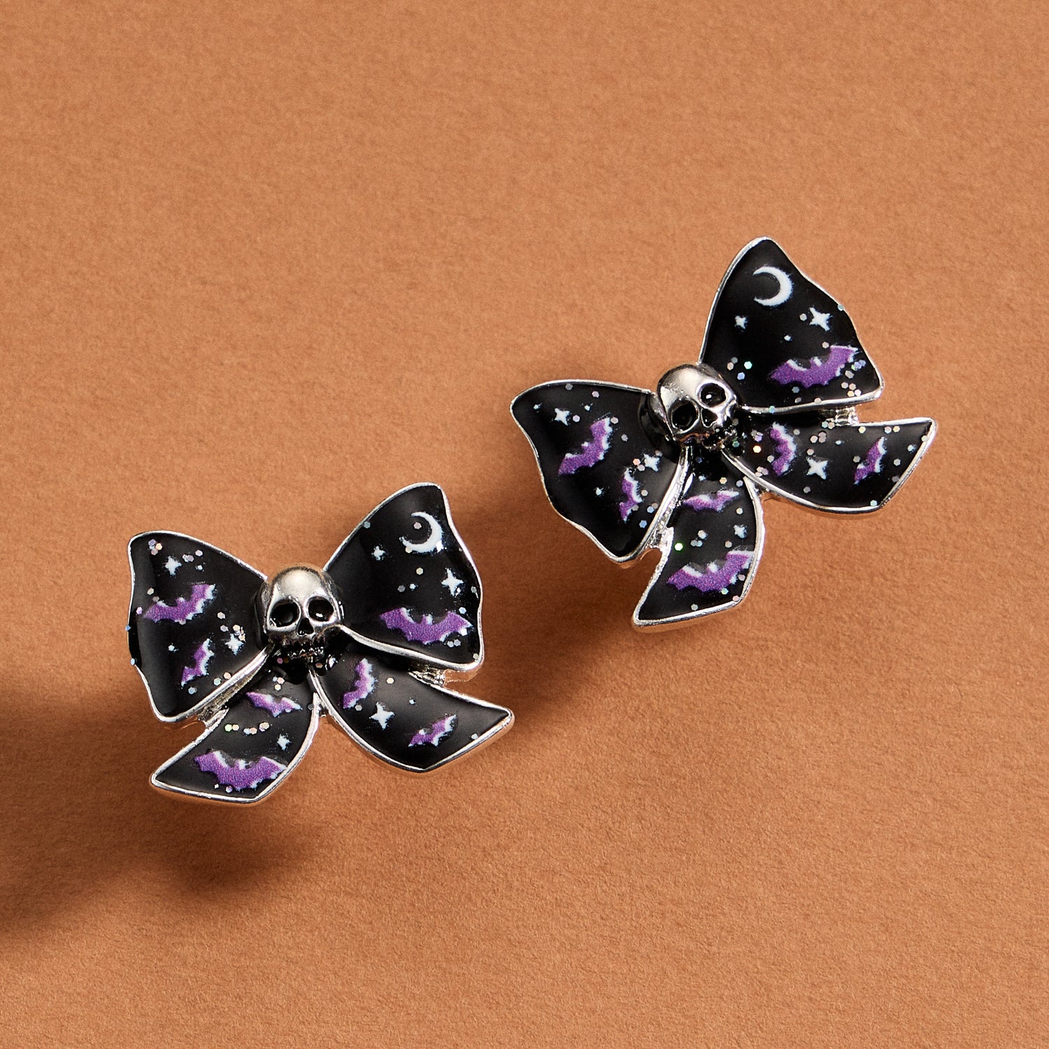 Enamel Skull Stud Earrings with Sculpted Bow Detail
