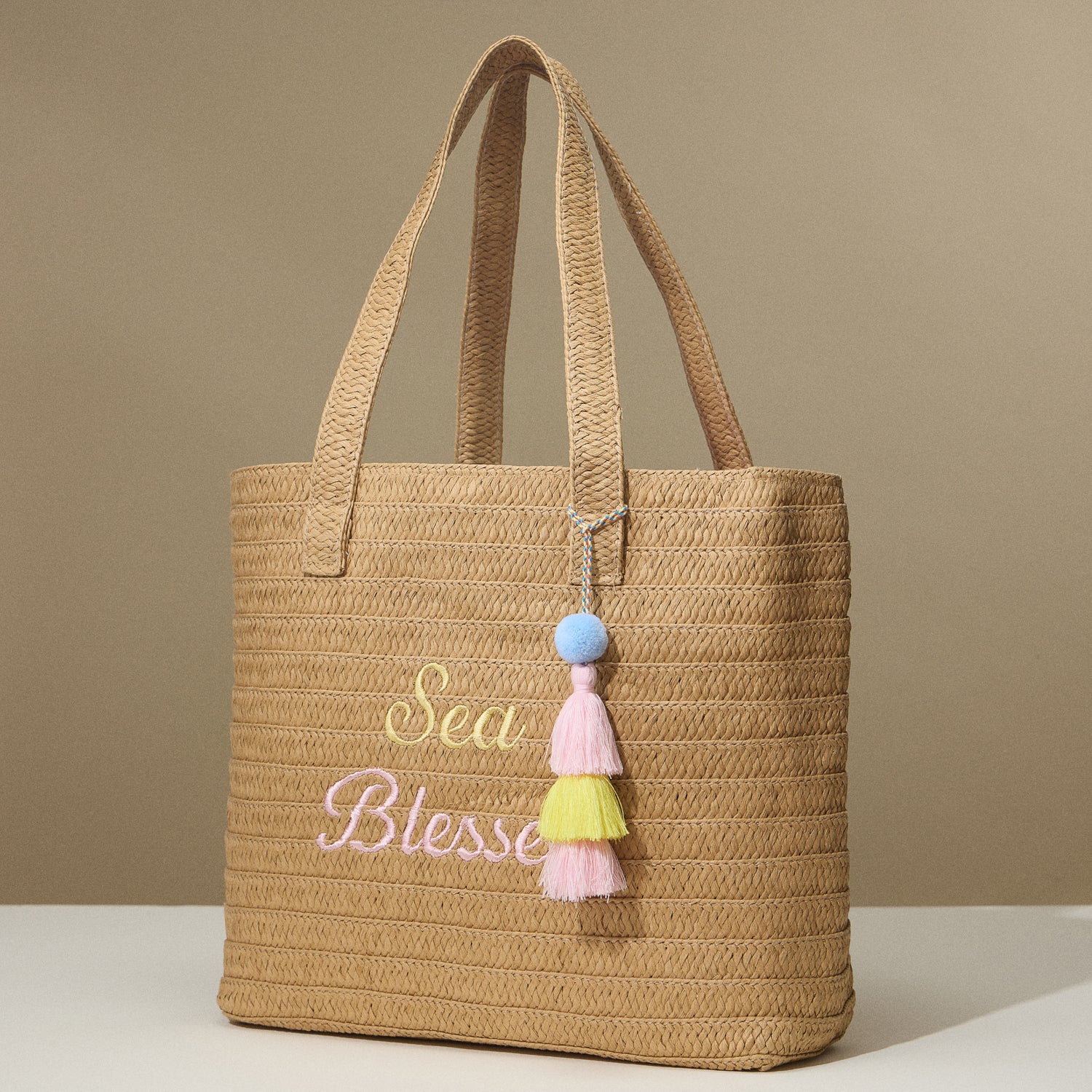 Sun Blessed Raffia Tote – Embroidered Woven Bag with Tassel Accent